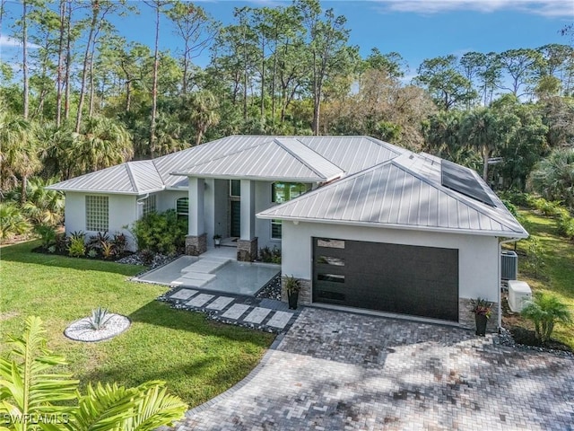 364 Logan Blvd S, Naples, FL 34119 - view of front of property featuring stucco siding, stone siding, a garage, a front lawn, and a metal roof