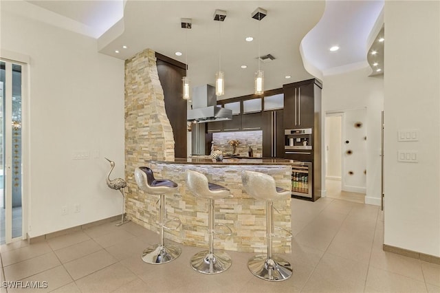 364 Logan Blvd S, Naples, FL 34119 - bar featuring island range hood, light tile patterned floors, decorative backsplash, and decorative light fixtures