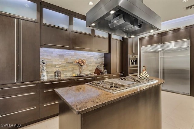 364 Logan Blvd S, Naples, FL 34119 - kitchen featuring appliances with stainless steel finishes, island exhaust hood, dark brown cabinets, and a center island