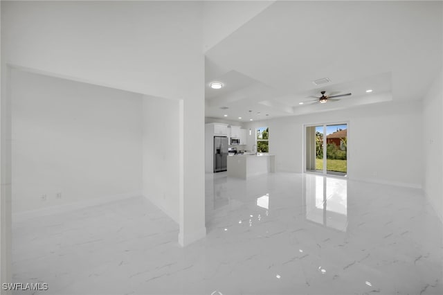 2605 28th St W, Lehigh Acres, FL 33971 - spare room featuring a raised ceiling, light marble finish floors, ceiling fan, and recessed lighting