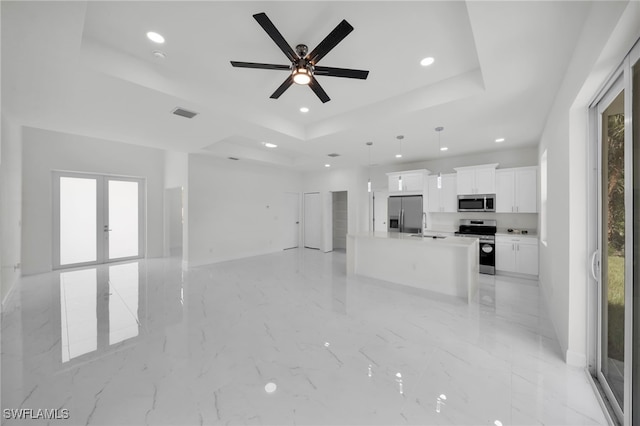 2605 28th St W, Lehigh Acres, FL 33971 - unfurnished living room featuring a raised ceiling, recessed lighting, ceiling fan, french doors, and light marble finish floors