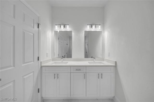 2605 28th St W, Lehigh Acres, FL 33971 - bathroom featuring double vanity and baseboards
