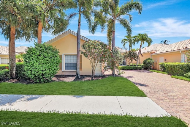3008 Ellice Way, Naples, FL 34119 - view of front of property featuring stucco siding, a front yard, and driveway