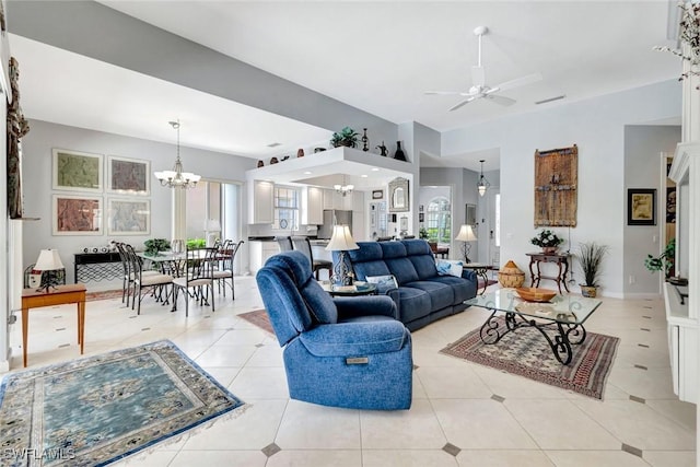 3008 Ellice Way, Naples, FL 34119 - living area with a ceiling fan, a chandelier, healthy amount of natural light, and light tile patterned flooring