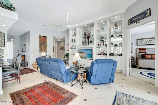 3008 Ellice Way, Naples, FL 34119 - living area with light tile patterned floors, ceiling fan, recessed lighting, and built in shelves