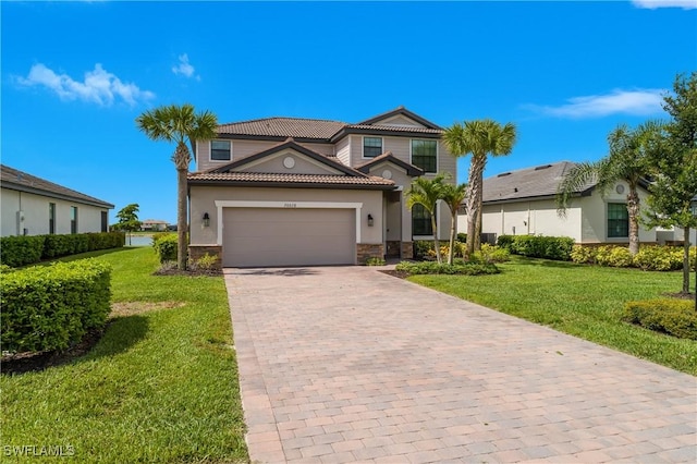 20028 Napa Loop, Estero, FL 33928 - mediterranean / spanish-style home featuring a tiled roof, decorative driveway, an attached garage, a front lawn, and stone siding