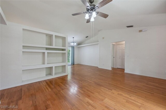 3210 2nd Ave SE, Naples, FL 34117 - unfurnished room with a chandelier, light wood finished floors, a ceiling fan, lofted ceiling, and built in shelves