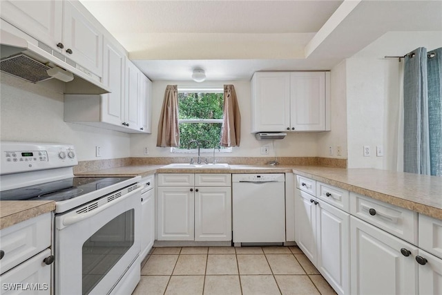 3210 2nd Ave SE, Naples, FL 34117 - kitchen with white appliances, under cabinet range hood, white cabinets, light tile patterned floors, and light countertops