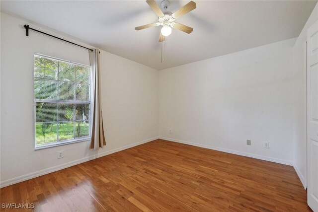 3210 2nd Ave SE, Naples, FL 34117 - empty room with healthy amount of natural light, light wood-type flooring, and ceiling fan