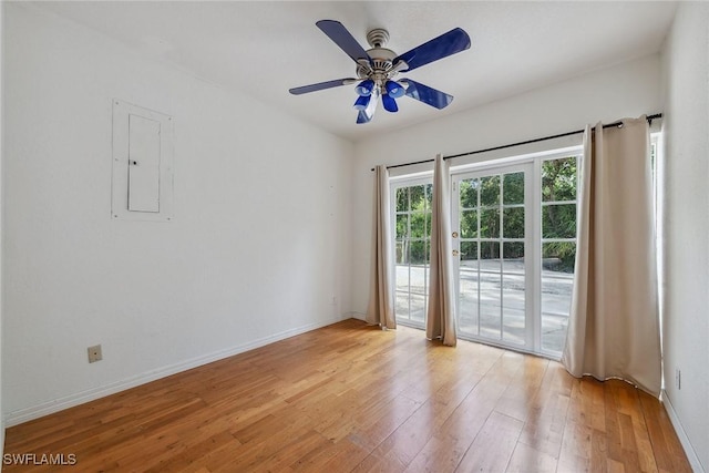 3210 2nd Ave SE, Naples, FL 34117 - empty room featuring electric panel, light wood finished floors, and ceiling fan