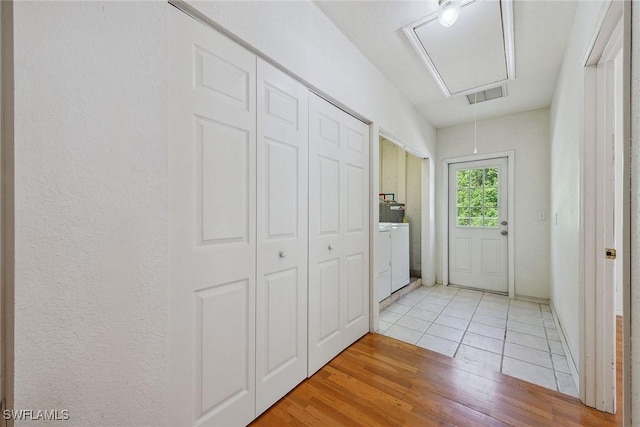 3210 2nd Ave SE, Naples, FL 34117 - laundry area with attic access, washer / clothes dryer, and light wood finished floors