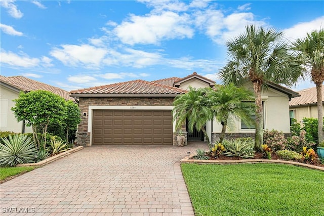 11288 Red Bluff Ln, Fort Myers, FL 33912 - mediterranean / spanish home featuring stone siding, an attached garage, decorative driveway, a front lawn, and stucco siding