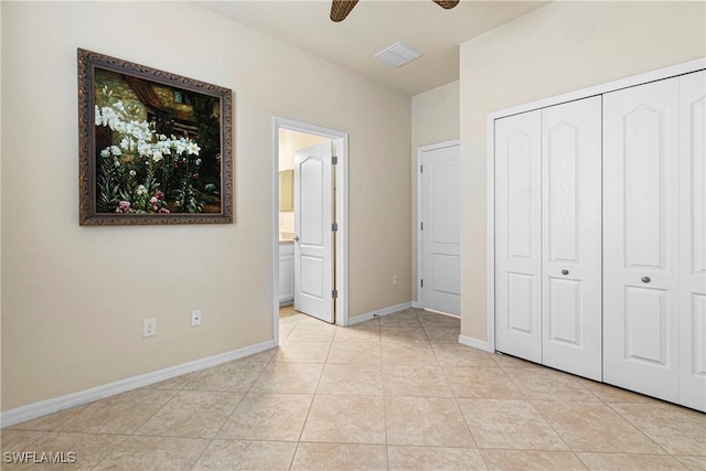 11288 Red Bluff Ln, Fort Myers, FL 33912 - unfurnished bedroom with light tile patterned floors, connected bathroom, a closet, and a ceiling fan