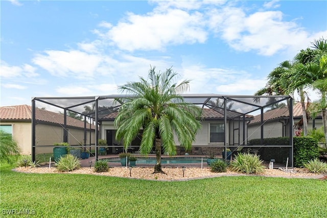 11288 Red Bluff Ln, Fort Myers, FL 33912 - rear view of house featuring a yard, glass enclosure, and stucco siding