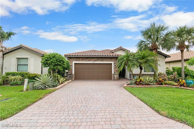 11288 Red Bluff Ln, Fort Myers, FL 33912 - view of front of house with decorative driveway, an attached garage, a front yard, and a tile roof