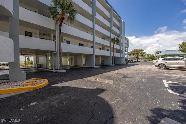 1085 Bald Eagle Dr Unit F409, Marco Island, FL 34145 - view of building exterior featuring uncovered parking