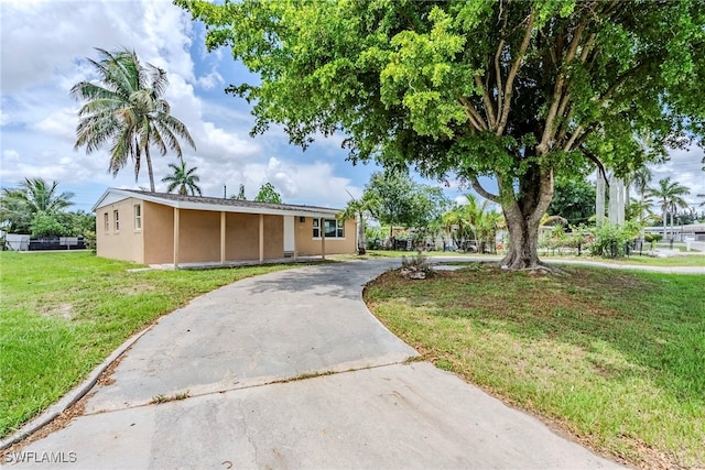 2414 Braman Ave, Fort Myers, FL 33901 - single story home with stucco siding, a front yard, and driveway