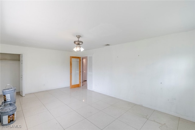 2414 Braman Ave, Fort Myers, FL 33901 - unfurnished bedroom featuring a closet and light tile patterned flooring
