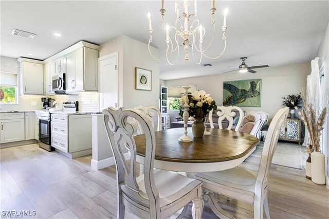 7208 Saint Anns Ct, Fort Myers, FL 33908 - dining area with a ceiling fan, light wood-style floors, a chandelier, and recessed lighting