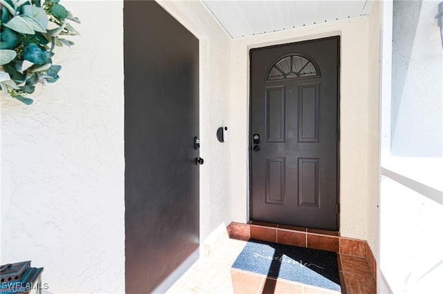 7208 Saint Anns Ct, Fort Myers, FL 33908 - doorway to property with stucco siding