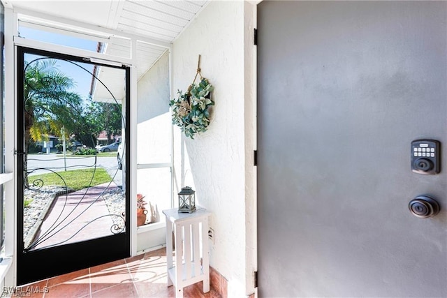 7208 Saint Anns Ct, Fort Myers, FL 33908 - foyer featuring a textured wall and tile patterned flooring