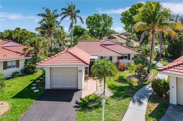 7208 Saint Anns Ct, Fort Myers, FL 33908 - mediterranean / spanish house with a tile roof, stucco siding, a front yard, and driveway