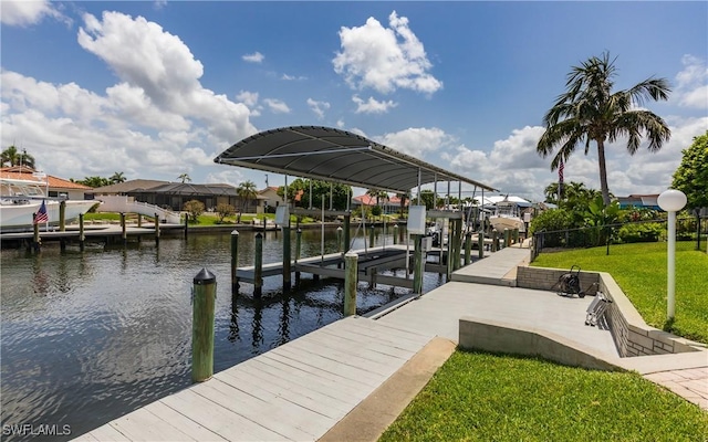 1221 SW 53rd Ter, Cape Coral, FL 33914 - dock featuring boat lift, a water view, and a yard