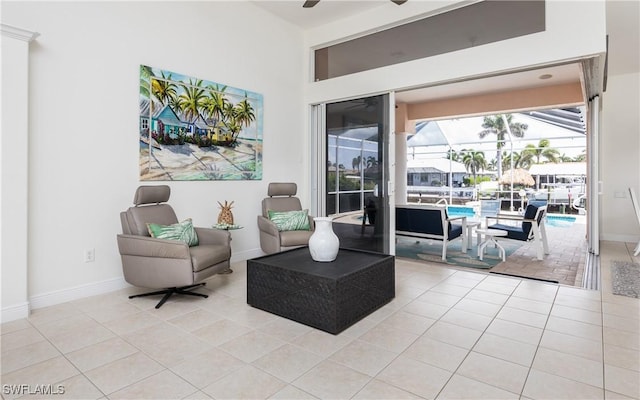 1221 SW 53rd Ter, Cape Coral, FL 33914 - living area featuring a sunroom, ceiling fan, and light tile patterned floors