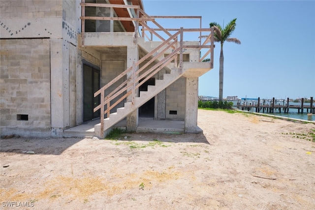 938 San Carlos Dr, Fort Myers Beach, FL 33931 - view of property exterior featuring a water view and stairway
