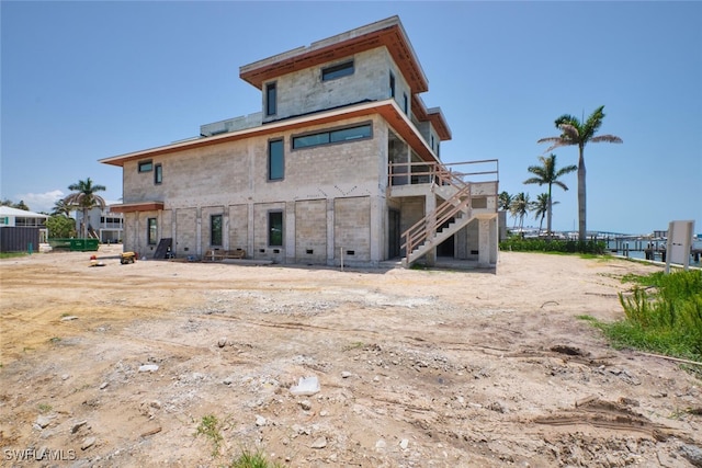 938 San Carlos Dr, Fort Myers Beach, FL 33931 - rear view of house with stairway and a wooden deck