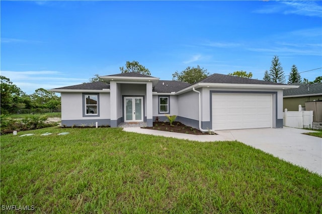 3103 Karen Ave S, Lehigh Acres, FL 33976 - view of front of home featuring stucco siding, french doors, an attached garage, and driveway