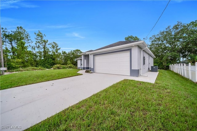 3103 Karen Ave S, Lehigh Acres, FL 33976 - view of side of property with driveway, a garage, and stucco siding