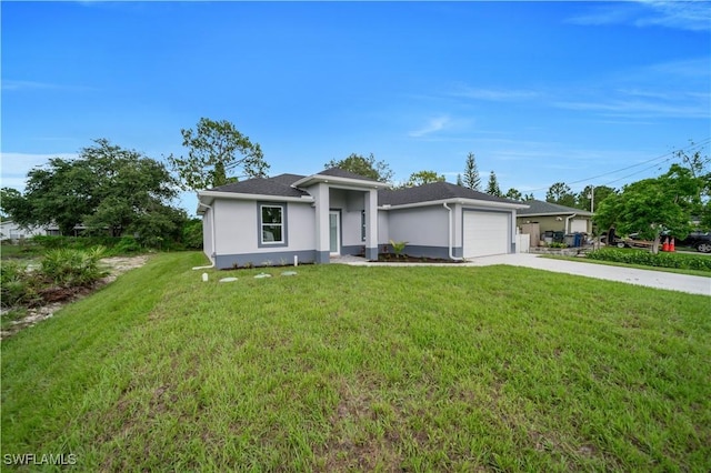 3103 Karen Ave S, Lehigh Acres, FL 33976 - view of front of house with an attached garage, concrete driveway, stucco siding, and a front yard