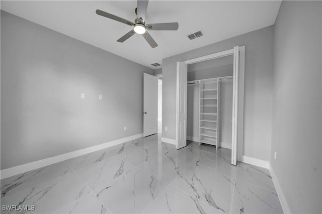 3103 Karen Ave S, Lehigh Acres, FL 33976 - unfurnished bedroom featuring marble finish floors, a closet, and ceiling fan
