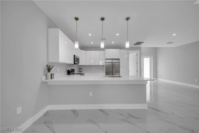 3103 Karen Ave S, Lehigh Acres, FL 33976 - kitchen with stainless steel appliances, white cabinets, light countertops, a peninsula, and recessed lighting