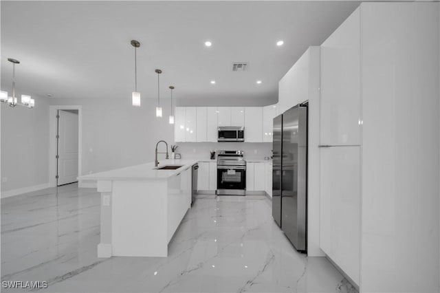 3103 Karen Ave S, Lehigh Acres, FL 33976 - kitchen featuring appliances with stainless steel finishes, a peninsula, modern cabinets, light marble finish flooring, and recessed lighting