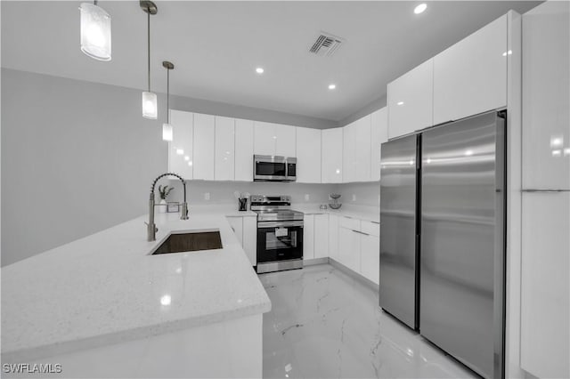 3103 Karen Ave S, Lehigh Acres, FL 33976 - kitchen with stainless steel appliances, recessed lighting, modern cabinets, white cabinets, and light stone countertops