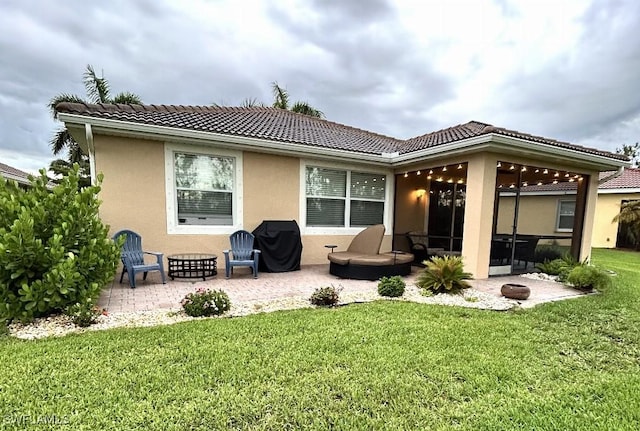 20608 Long Pond Rd, North Fort Myers, FL 33917 - back of property featuring a patio area, a tile roof, a yard, stucco siding, and a sunroom