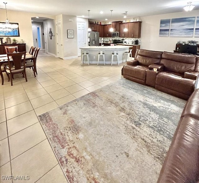 20608 Long Pond Rd, North Fort Myers, FL 33917 - living area featuring light tile patterned floors, recessed lighting, a chandelier, and arched walkways