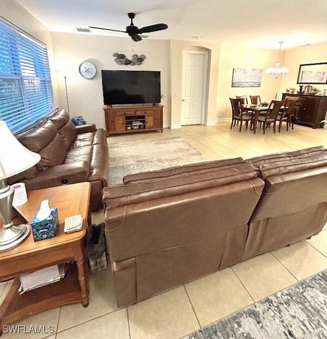 20608 Long Pond Rd, North Fort Myers, FL 33917 - living area featuring tile patterned floors, a ceiling fan, and a chandelier