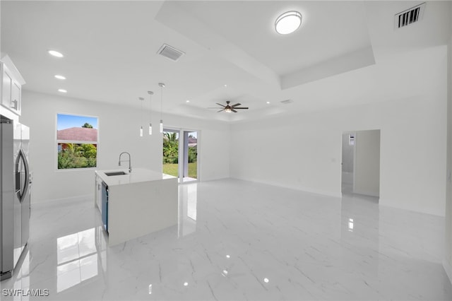 2817 22nd St W, Lehigh Acres, FL 33971 - unfurnished living room featuring a tray ceiling, recessed lighting, a ceiling fan, and light marble finish floors