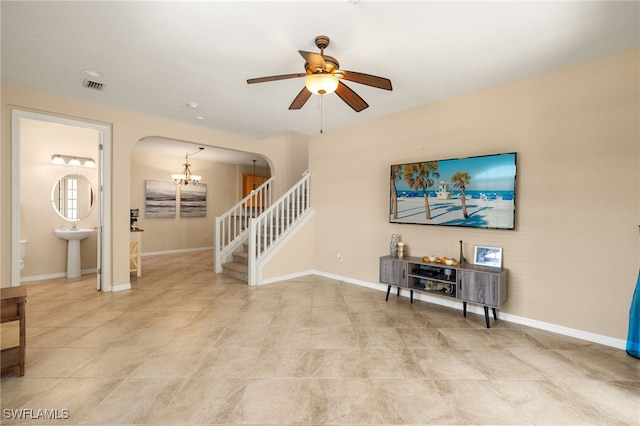 11999 Palba Way Unit 6405, Fort Myers, FL 33912 - living area featuring arched walkways, ceiling fan, stairs, a chandelier, and light tile patterned flooring