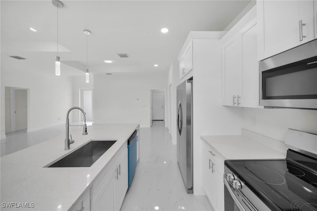 2511 23rd St W, Lehigh Acres, FL 33971 - kitchen with appliances with stainless steel finishes, white cabinetry, recessed lighting, pendant lighting, and light marble finish floors