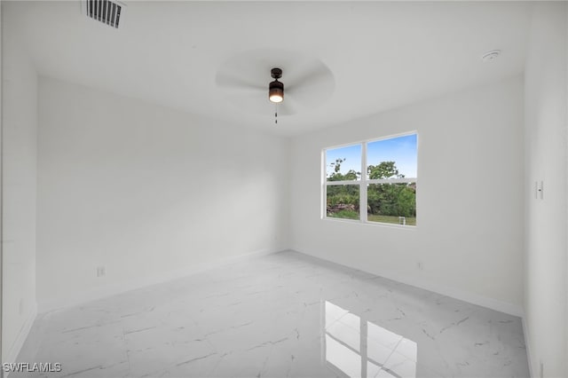 2511 23rd St W, Lehigh Acres, FL 33971 - unfurnished room with a ceiling fan, light marble finish floors, and a smoke detector