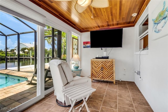 5251-5253 Serenity Cv, Bokeelia, FL 33922 - sunroom with a ceiling fan, a swimming pool, and a water view
