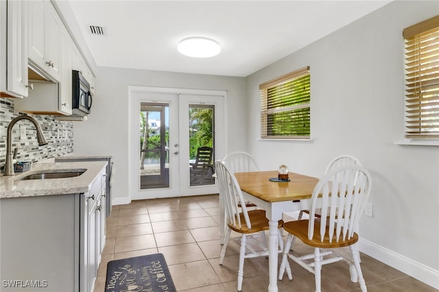 5251-5253 Serenity Cv, Bokeelia, FL 33922 - dining area featuring french doors and light tile patterned floors