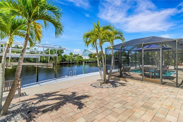 5251-5253 Serenity Cv, Bokeelia, FL 33922 - view of patio with an outdoor pool, a lanai, boat lift, a dock, and a water view