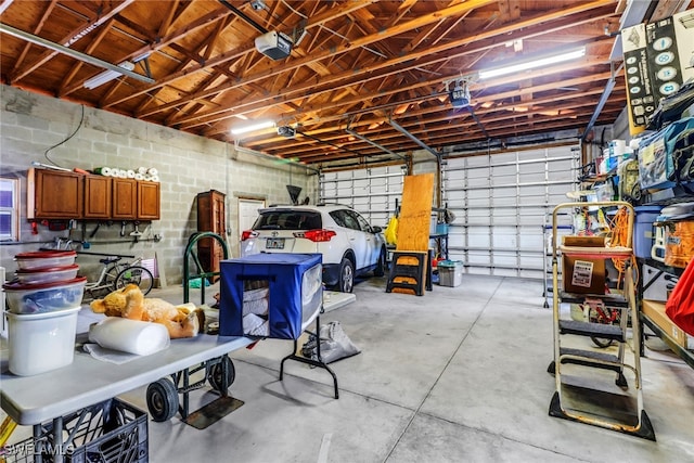 5251-5253 Serenity Cv, Bokeelia, FL 33922 - garage with concrete block wall and a garage door opener