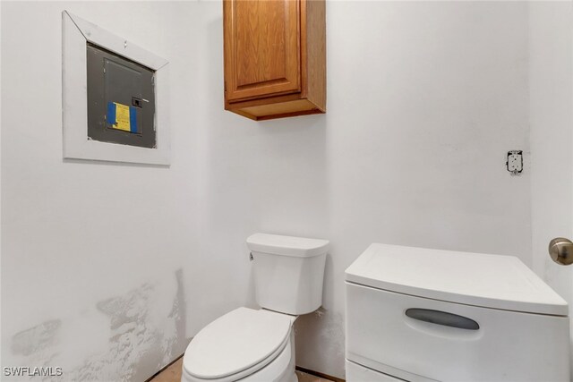 5251-5253 Serenity Cv, Bokeelia, FL 33922 - bathroom featuring toilet and electric panel