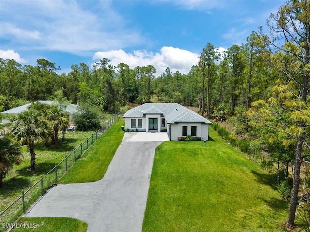 4325 47th Ave NE, Naples, FL 34120 - view of front of house featuring driveway and a view of trees